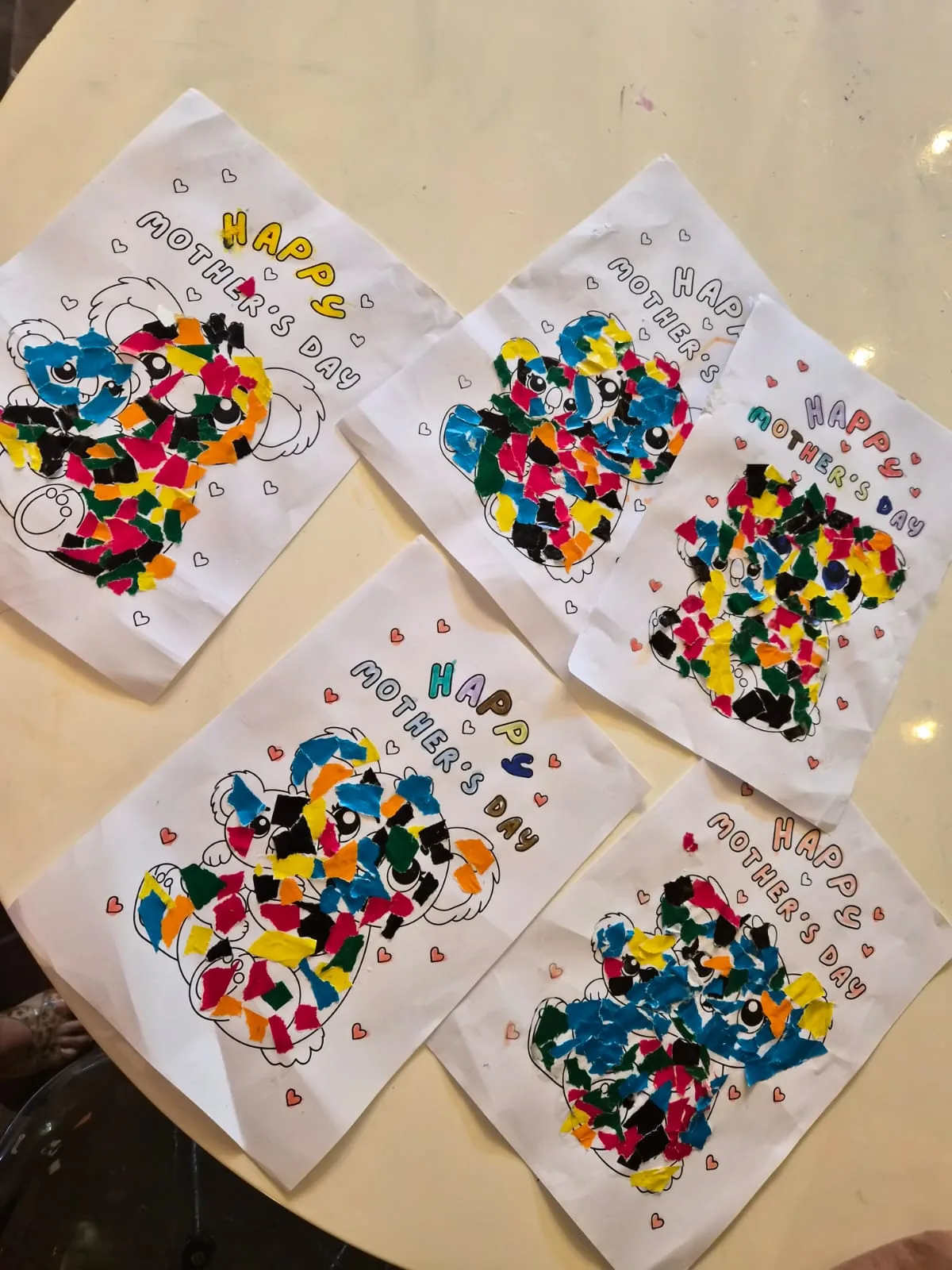 Five handmade Mother's Day cards decorated with torn coloured paper mosaic