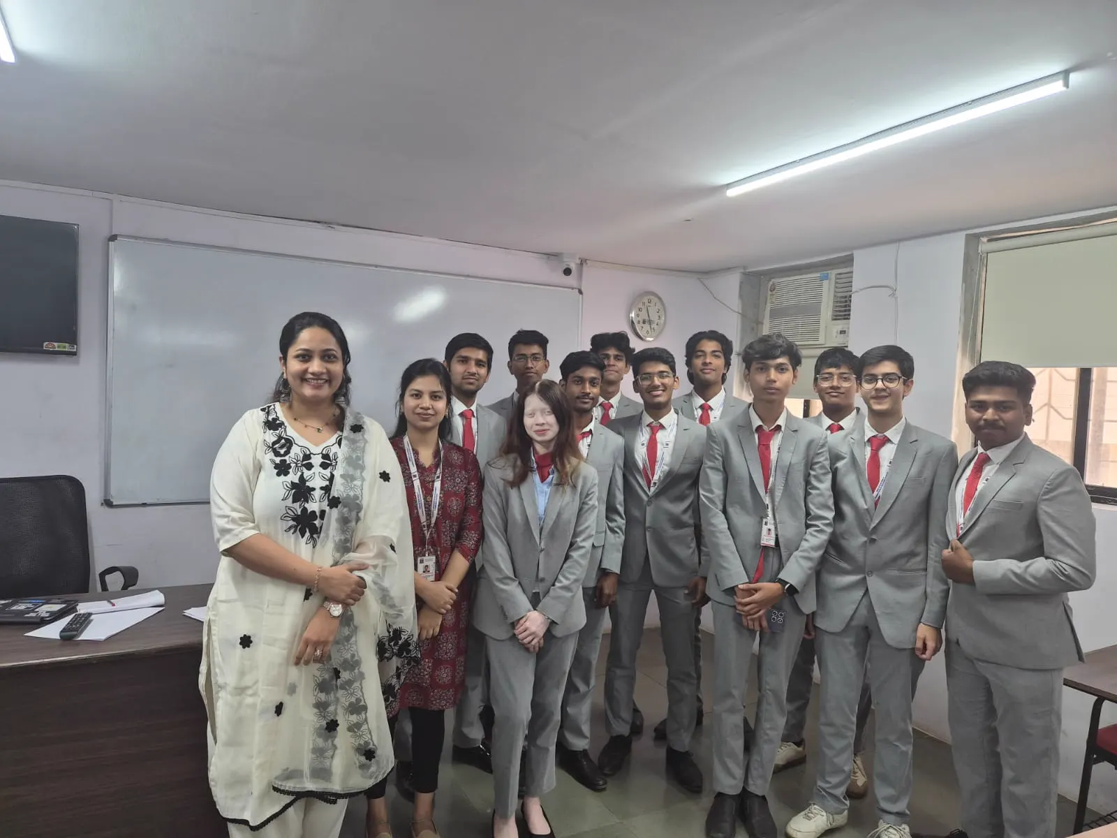 Aisha Arsh Khan with her IG, IB and A Levels cohort in formal blazers inside a DUAA Academy classroom